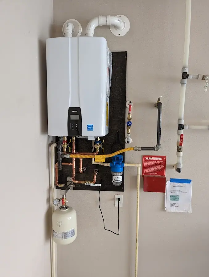 Professional plumber installing copper piping in a Lesslie home